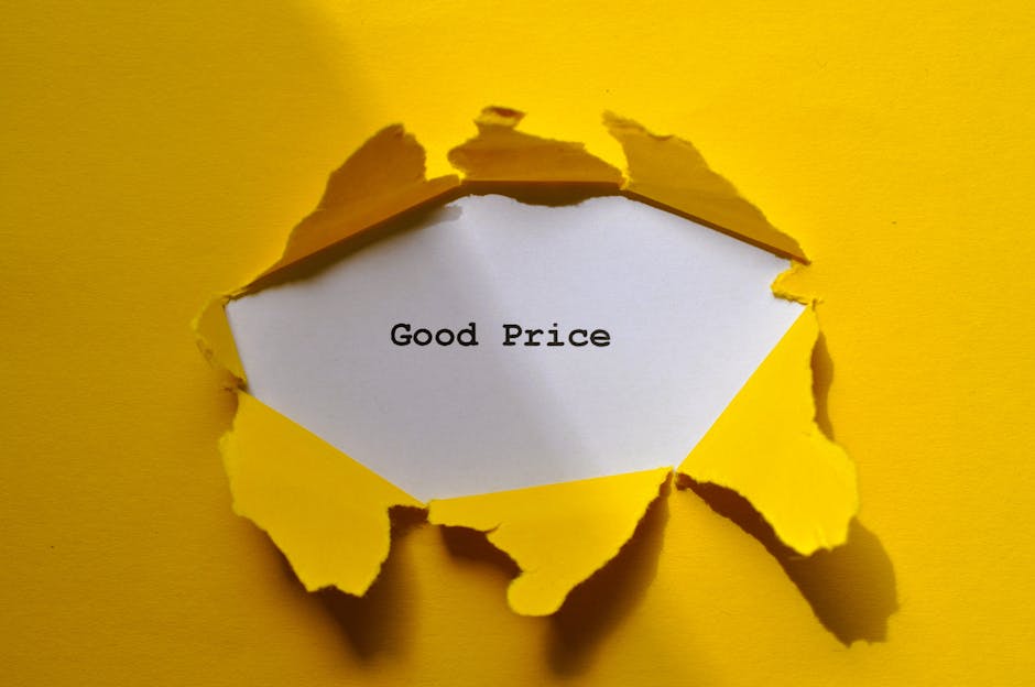 A close-up image of a piece of torn yellow paper peeling back to reveal a white section underneath, with the words 'Good Price' typed in black ink. The torn edges of the yellow paper are irregular and